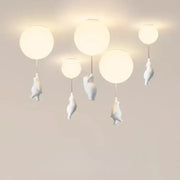 White ceramic balloon bear pendant light with bear figurines hanging below each globe for bedroom ceiling use