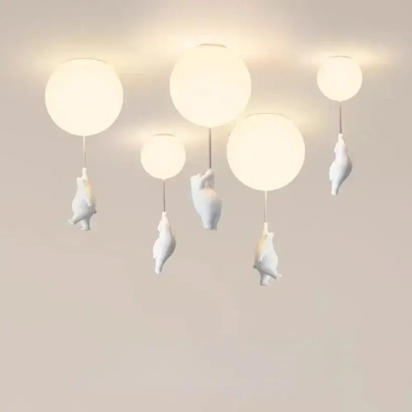 White ceramic balloon bear pendant light with bear figurines hanging below each globe for bedroom ceiling use