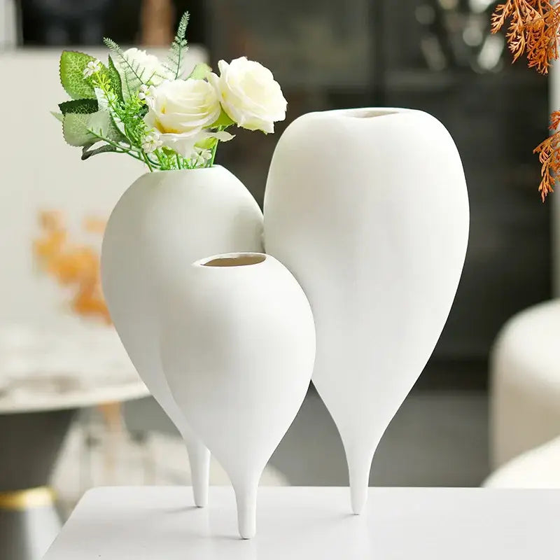 Three elegant white ceramic balloon geometric vases with teardrop shapes and slender legs for living room decor