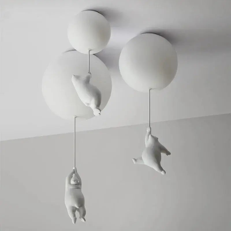White ceramic bear cartoon pendant lamp featuring polar bear figurines hanging from spherical light fixtures for kids bedroom