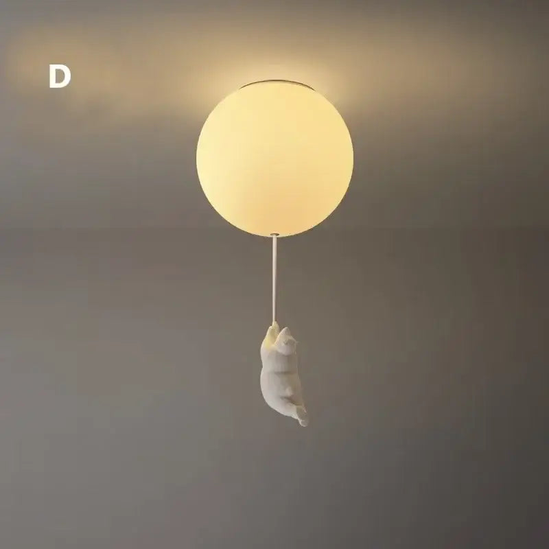 White ceramic bear led ceiling chandelier with warm-toned glass globe light and ceramic cat figurine hanging below