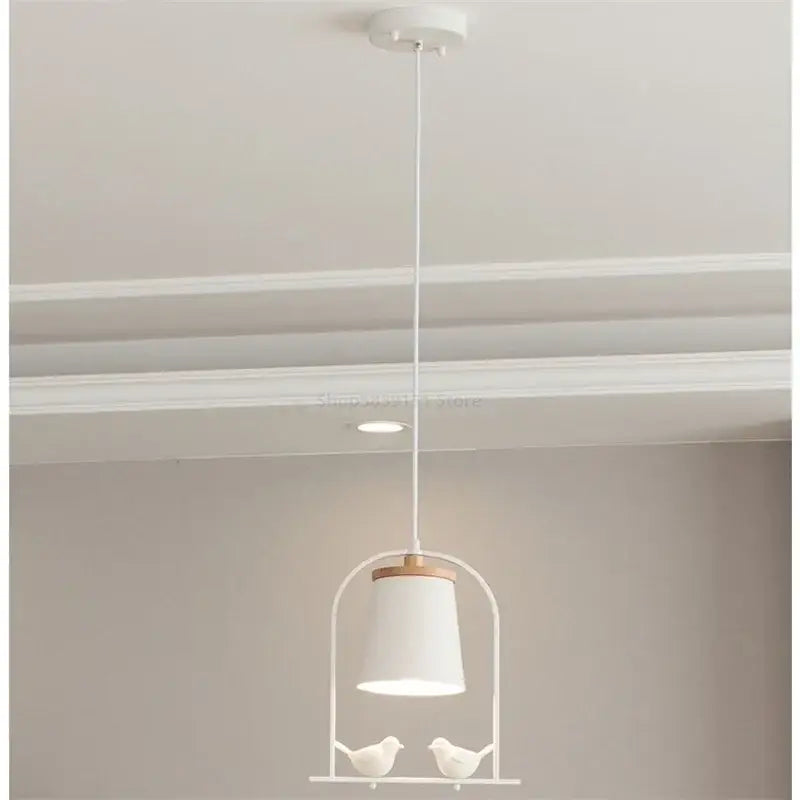 White ceramic bird led pendant light with matte shade wooden accent and two small white birds for dining room decorbites bird led