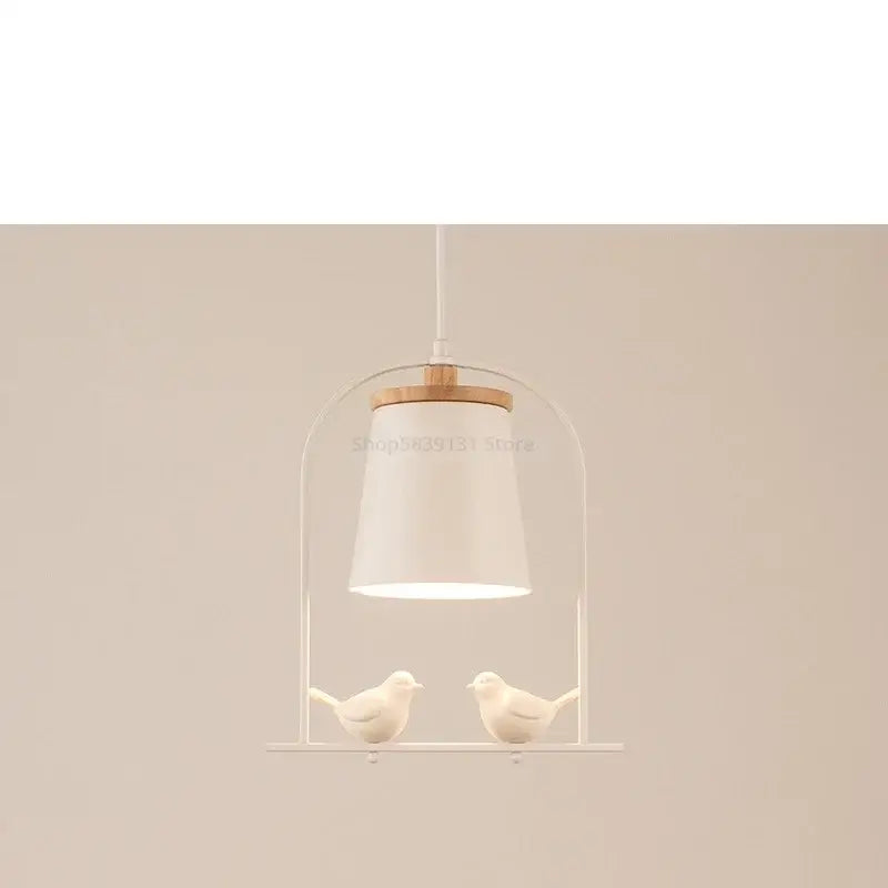 White ceramic bird led pendant light with wooden accent and two small bird figurines for dining room decorbites pendant light