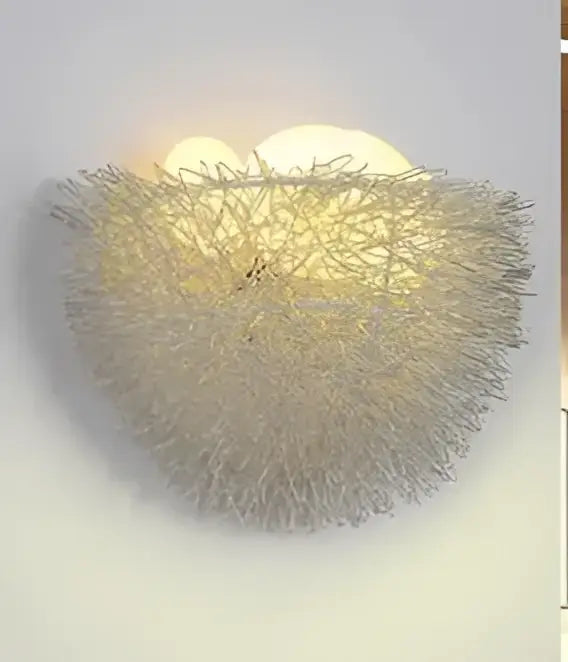 A delicate silver-toned wall lamp with woven wireframe design resembling an organic bird nest led decorbites bird nest