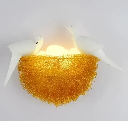 White ceramic bird nest led wall lamp with glowing golden nest and two white bird sculptures for decorbites bird nest decor