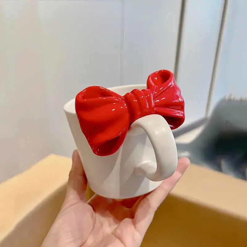 White ceramic bow knot mug with glossy red bow on handle made of porcelain ideal for dining room decorbites bow knot