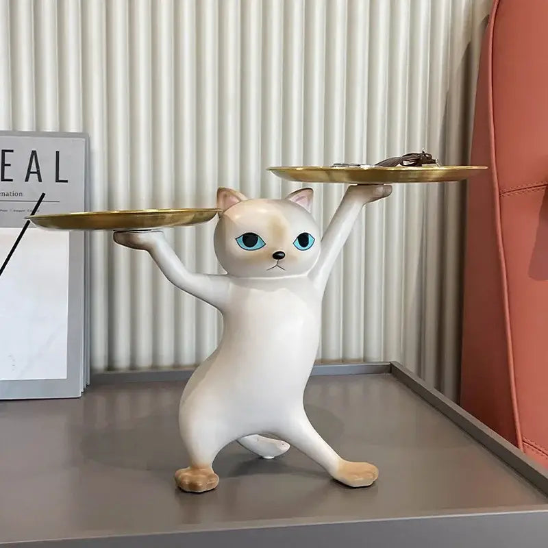 White ceramic cat tray sculpture with blue eyes balancing two gold trays for office desk storage accessory