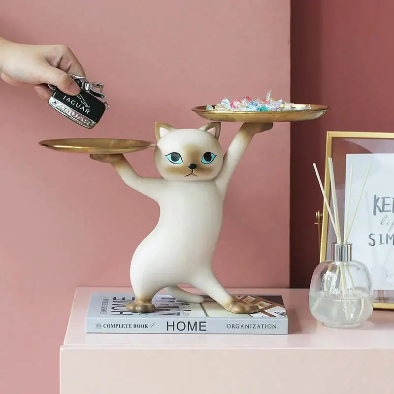 Cream-colored resin cat tray sculpture with blue eyes and two gold trays, ideal as an office desk storage accessory
