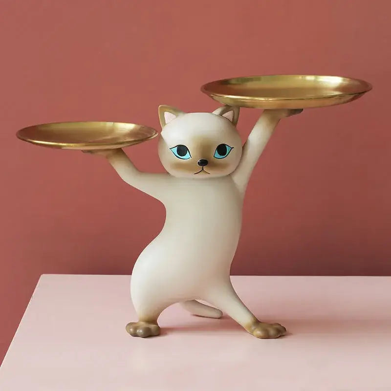 Cream-colored ceramic cat tray sculpture with blue eyes balancing two gold-toned plates for desk storage accessory