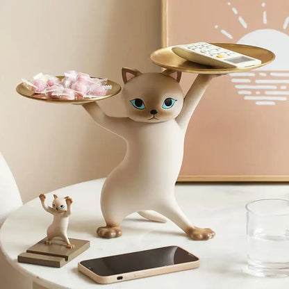 Cream-colored ceramic cat tray sculpture with blue eyes balancing two gold trays for office desk storage accessory
