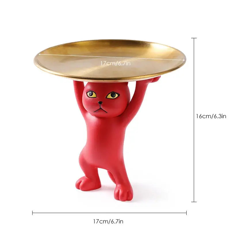 Red plastic cat tray sculpture holding a gold metal tray for office desk storage accessory