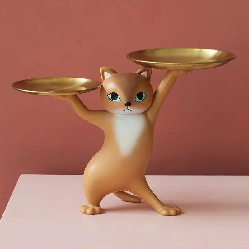 Tan ceramic cat tray sculpture with turquoise eyes and white chest holding two gold-colored plates for desk storage