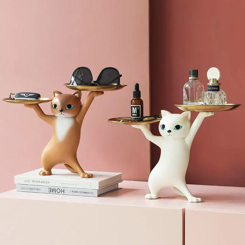 Two whimsical tan and white resin cat tray sculptures with golden trays for office desk storage accessory