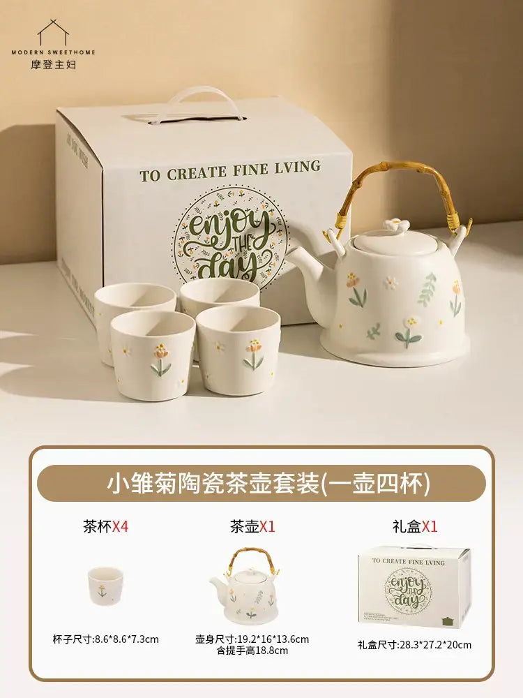White ceramic daisy teapot set with delicate floral decals and woven bamboo handle in an elegant gift box
