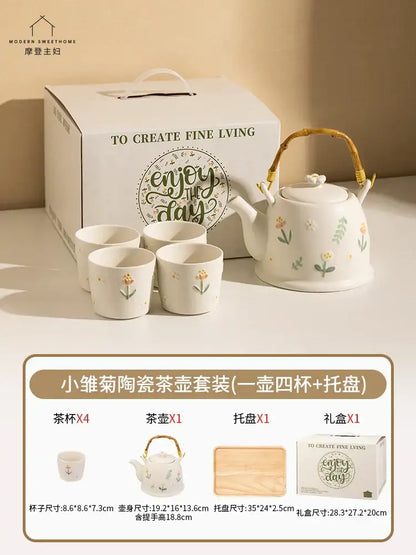 White ceramic daisy teapot set with floral decals and woven bamboo handle for elegant kitchen tea use