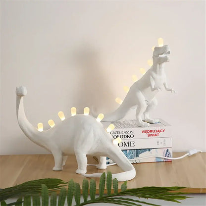White ceramic dino led desk lamp with glowing led lights along its back and tail for bedroom decorbites dino led lighting