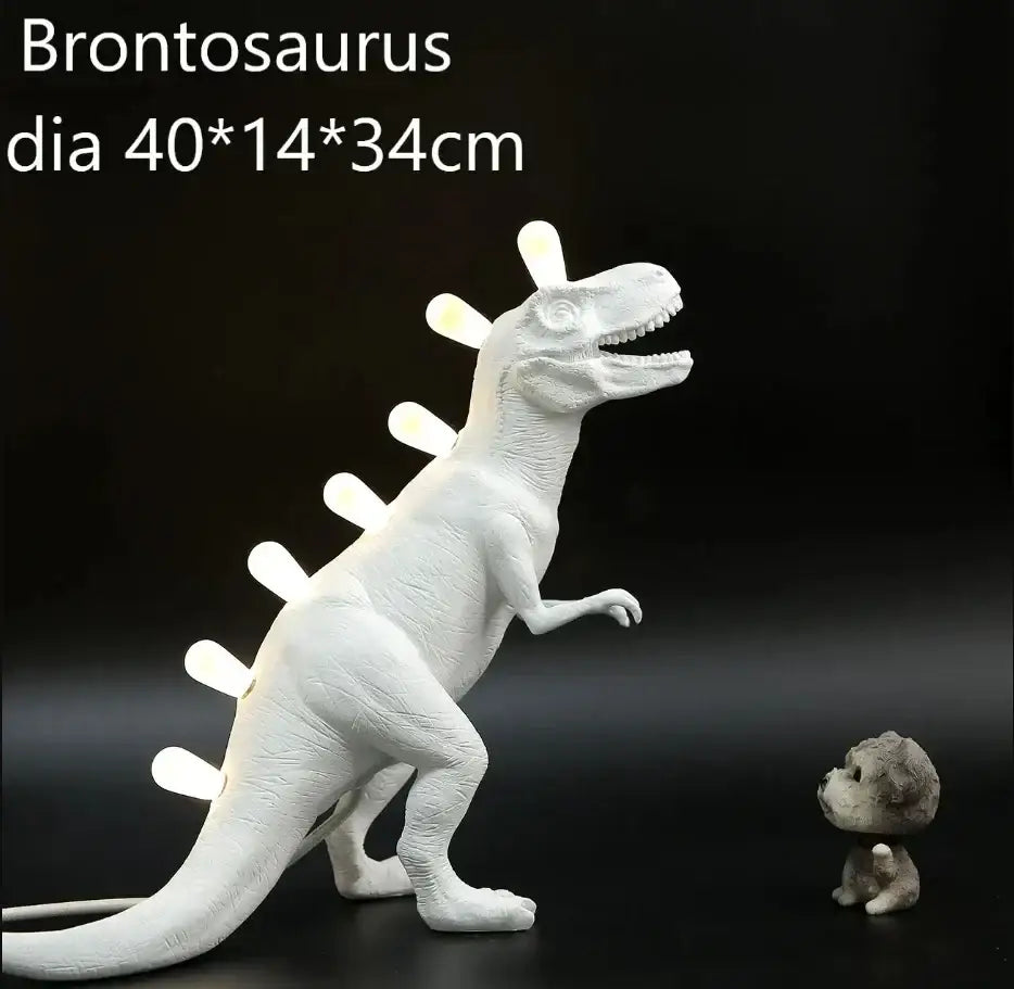 White ceramic dino led desk lamp shaped like a brontosaurus with glowing led spines for bedroom decorbites dino led