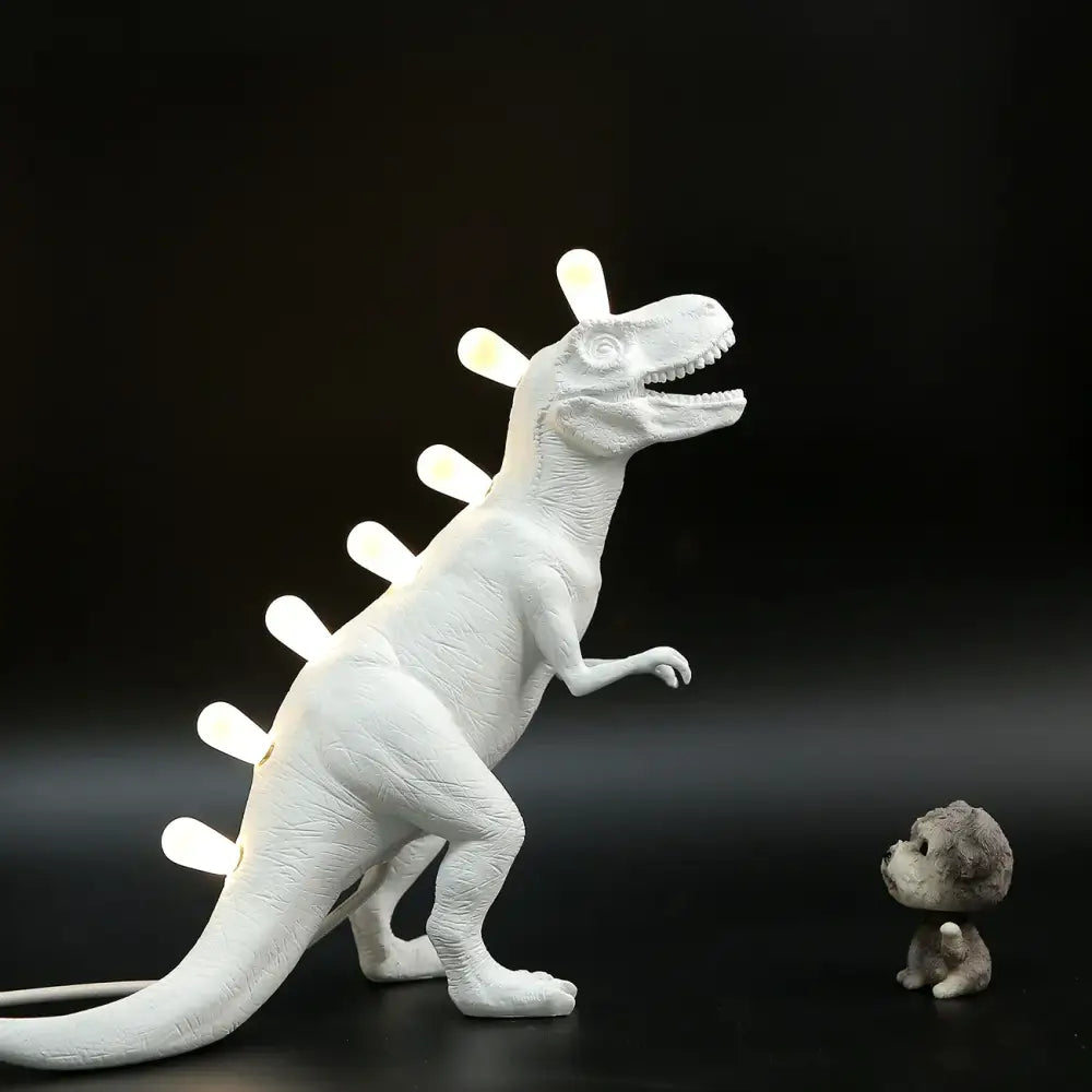 White ceramic dino led desk lamp with glowing led lights along its back for bedroom decorbites dino led lighting