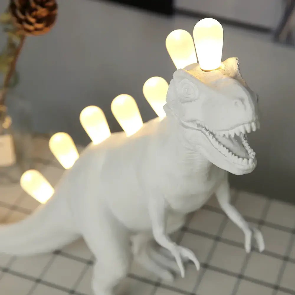 White ceramic dino led desk lamp with glowing bulb spines for bedroom decorbites dino led lighting