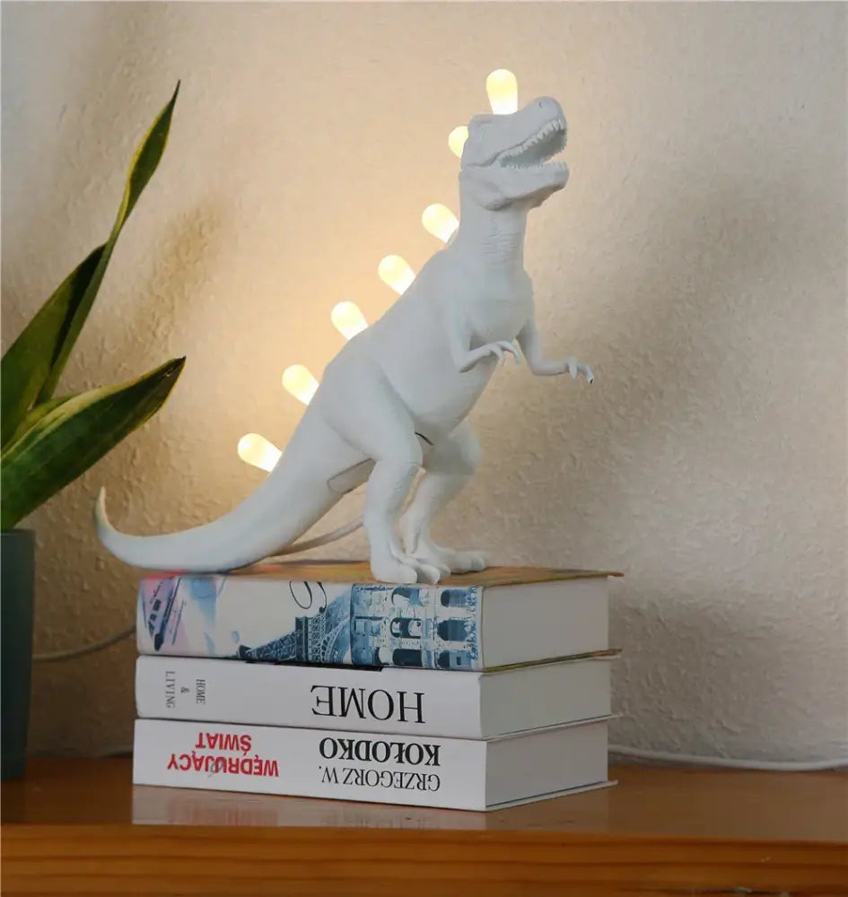 White ceramic dino led desk lamp with glowing t-rex design for bedroom lighting from decorbites dino led collection