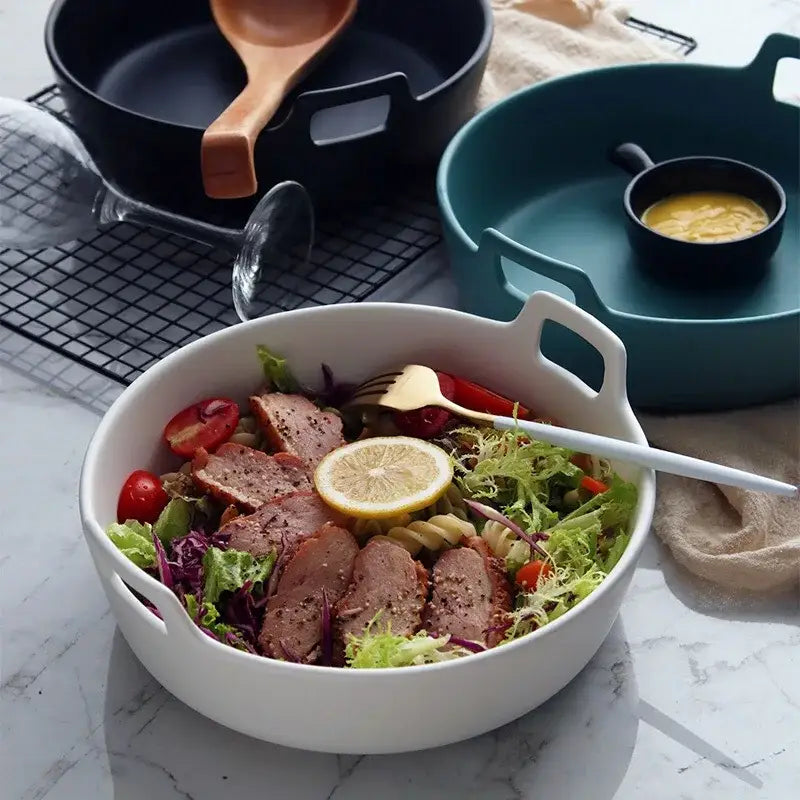 White ceramic double handle salad bowl by decorbites filled with greens sliced meat and pasta for dining room use