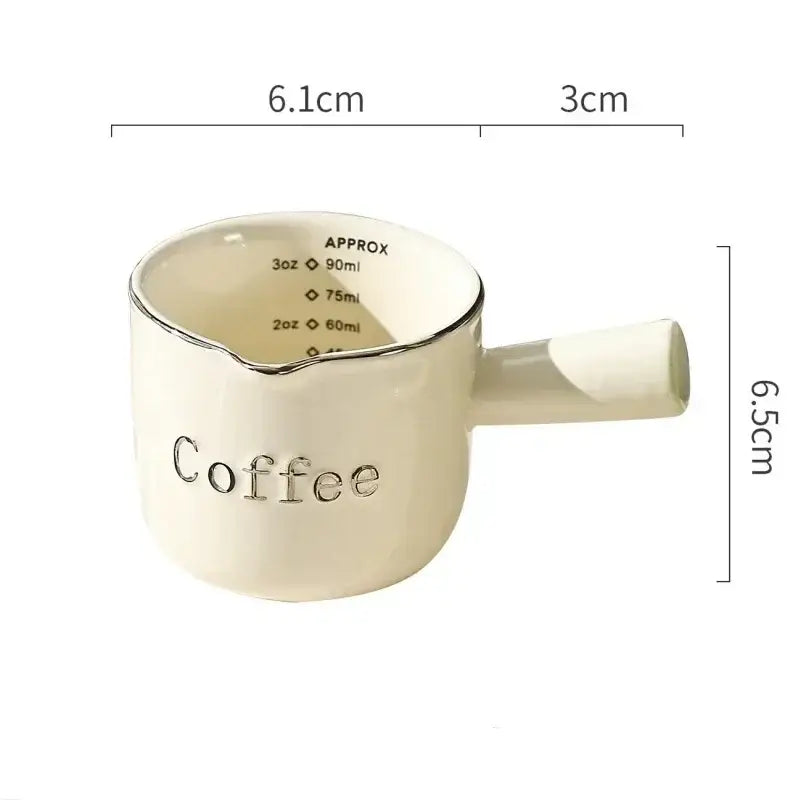 Cream-colored ceramic espresso measuring cup with silver rim and handle engraved coffee for decorbites latte mixer and milk pitcher