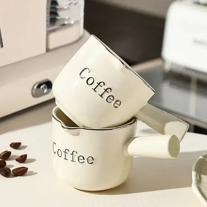 White ceramic espresso measuring cup and milk pitcher with silver lettering and rim accents ideal for latte mixer decorbites espresso measuring use