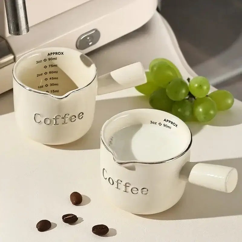 White ceramic espresso measuring cups with silver rim and handle engraved with coffee for milk pitcher and latte mixer decorbites espresso measuring use