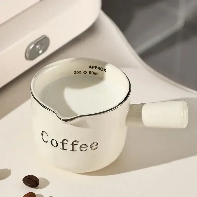 White ceramic espresso measuring cup and milk pitcher with silver rim and handle marked coffee for decorbites espresso measuring