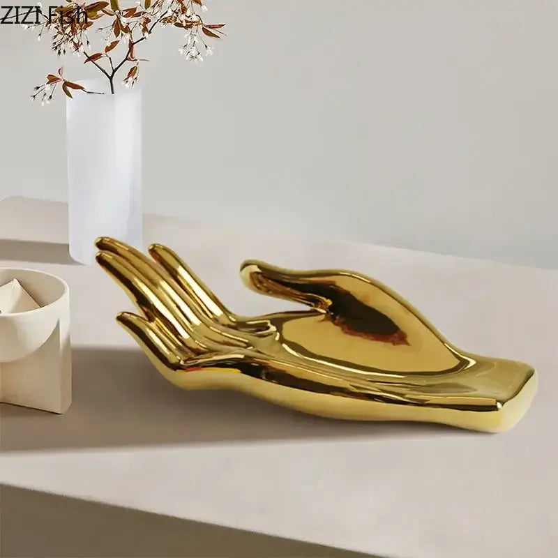 Golden ceramic hand-shaped fruit plate tray with smooth reflective surface ideal for living room decor