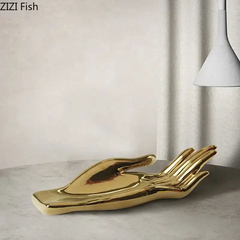 Golden ceramic hand fruit plate tray with smooth reflective surface and minimalist design for living room decor