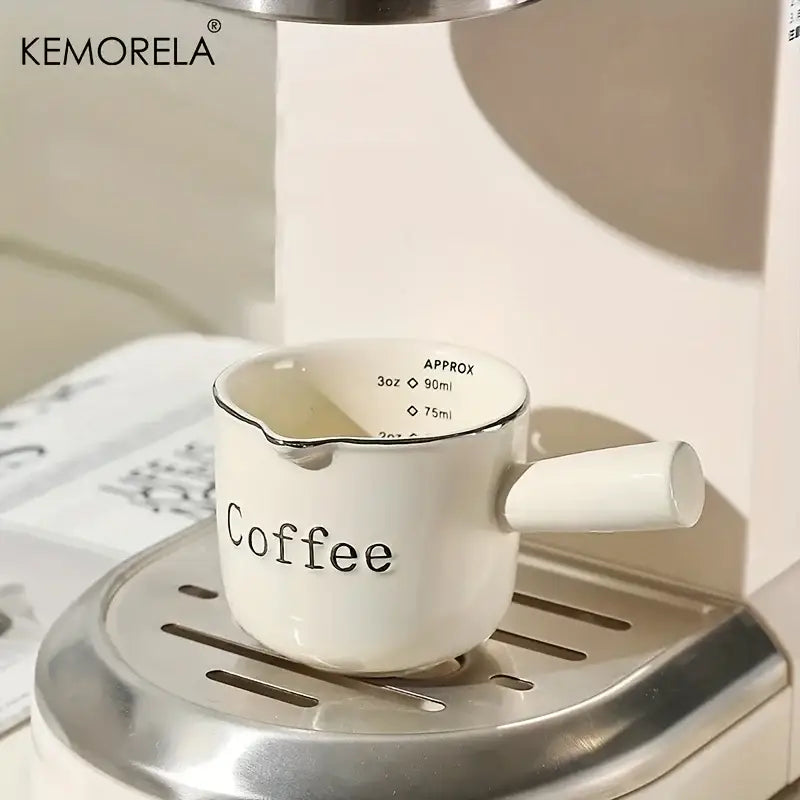 White ceramic measuring cup with black coffee lettering and silver rim from decorbites ceramic measuring cups set