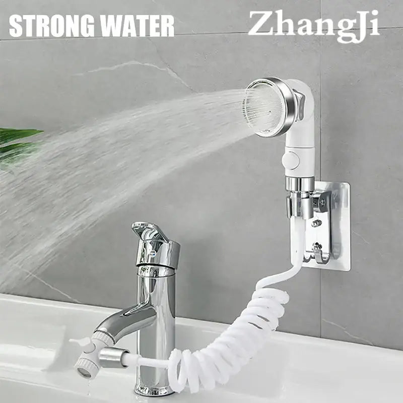 White and chrome handheld shower nozzle with flexible coiled hose mounted on wall for versatile bathroom use
