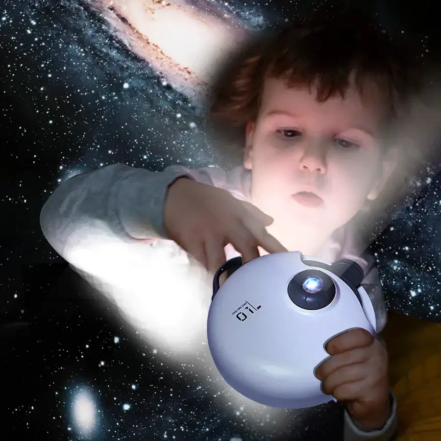 White circular decorbites galaxy starry projector night light with black accents and blue glowing lens for children