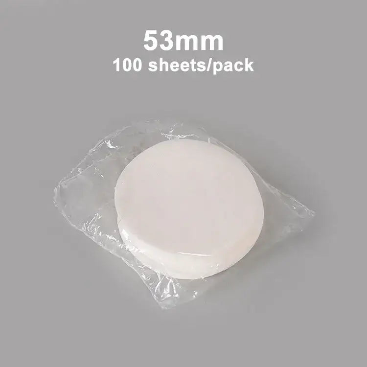 A stack of 53mm white circular disposable coffee filter papers in clear packaging for decorbites coffee filter use