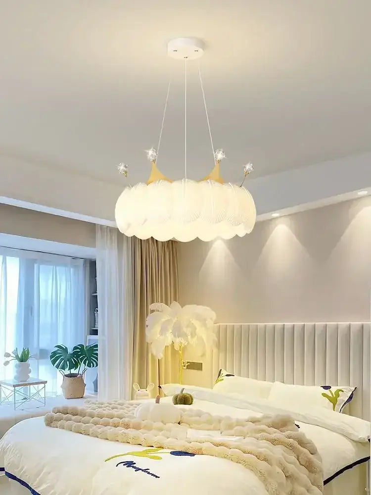 White cloud led crown small chandelier with feathery texture and gold accents hanging in a bedroom light