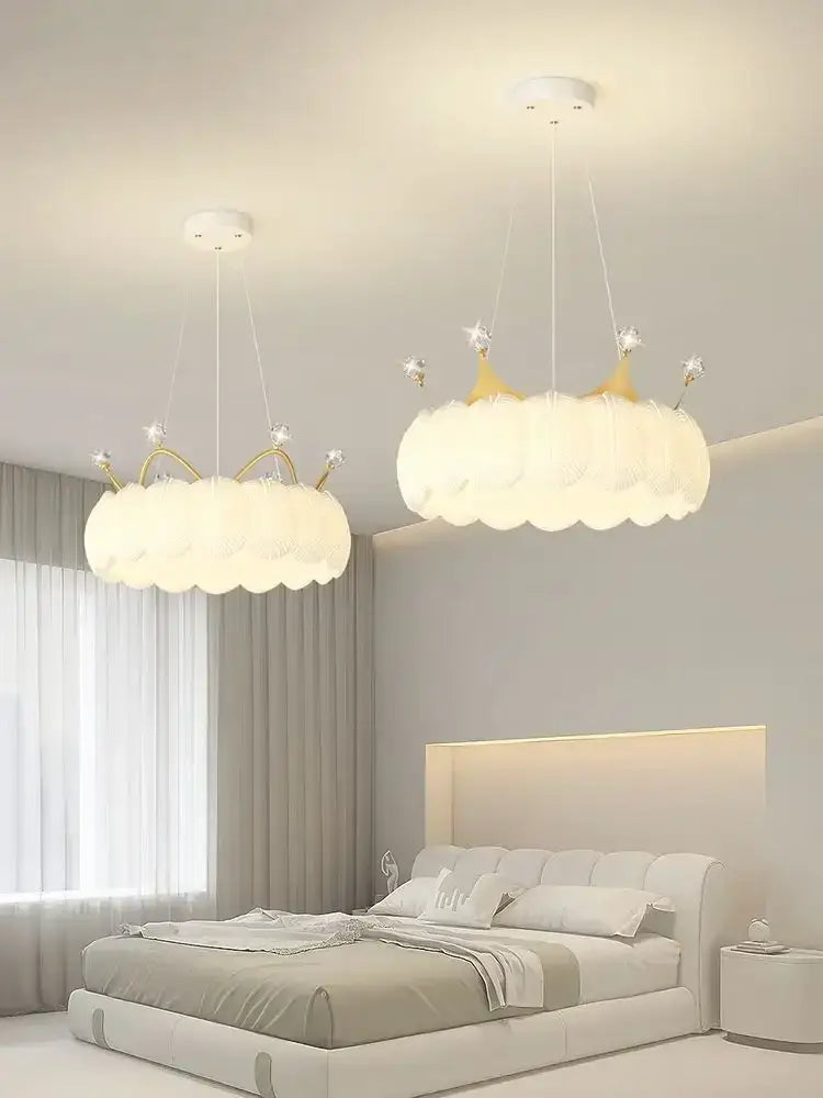 Two elegant white cloud led crown small chandeliers with gold accents and star details for bedroom lighting
