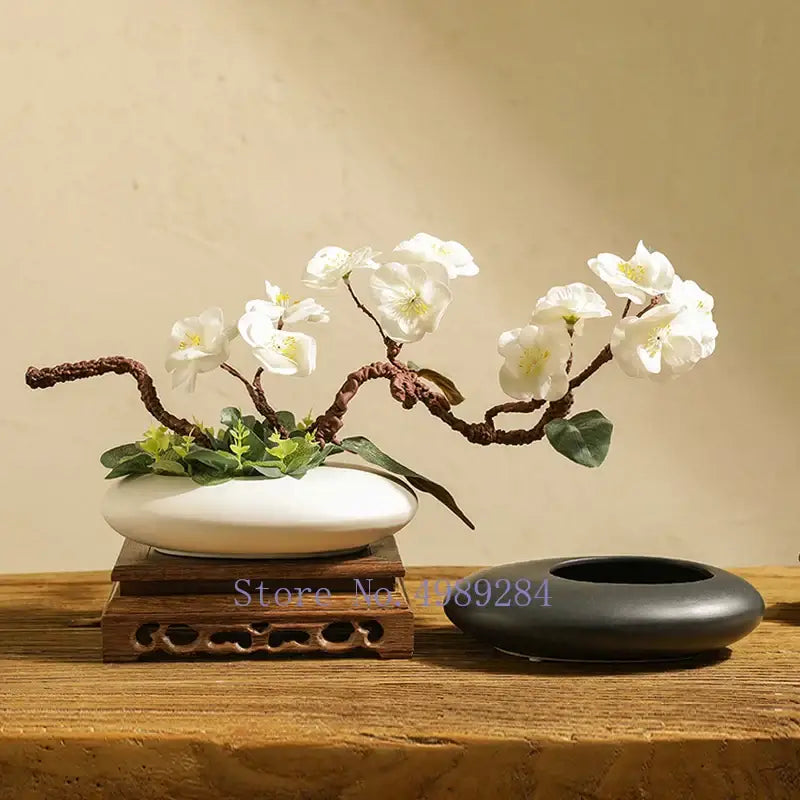 White cobblestone deformation ceramic bonsai pot with curved brown branches and delicate white blossoms for decorbites decor