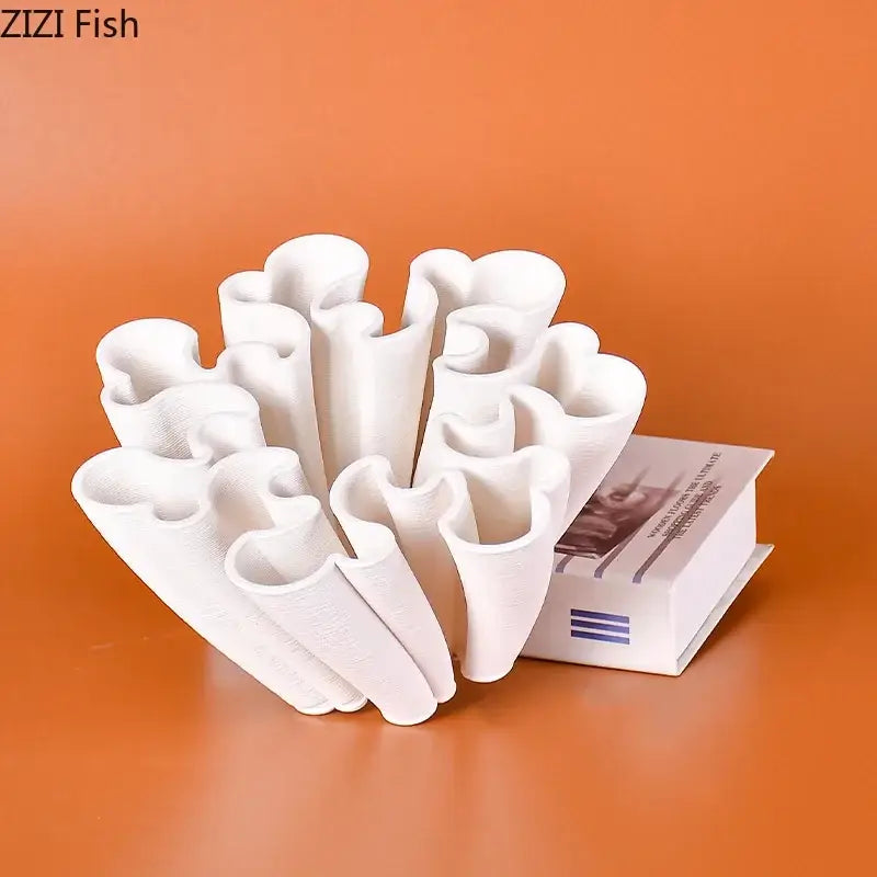 White ceramic coral sculpture with intricate branching arms and a smooth glossy finish as a ceramic vase plant decor