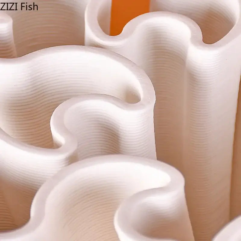 White wavy-edged plastic cookie cutters with glossy finish and visible 3d print layers for ceramic vase plant decor