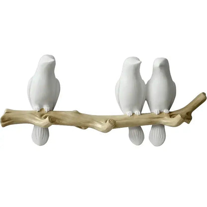 White decorbites bird resin hanger kitchen hook featuring a white ceramic bird figurine set on natural wood branch