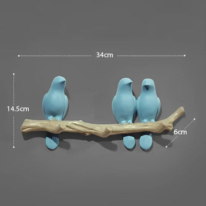 Blue ceramic decorbites bird resin hanger on a natural wood branch base for kitchen wall decor