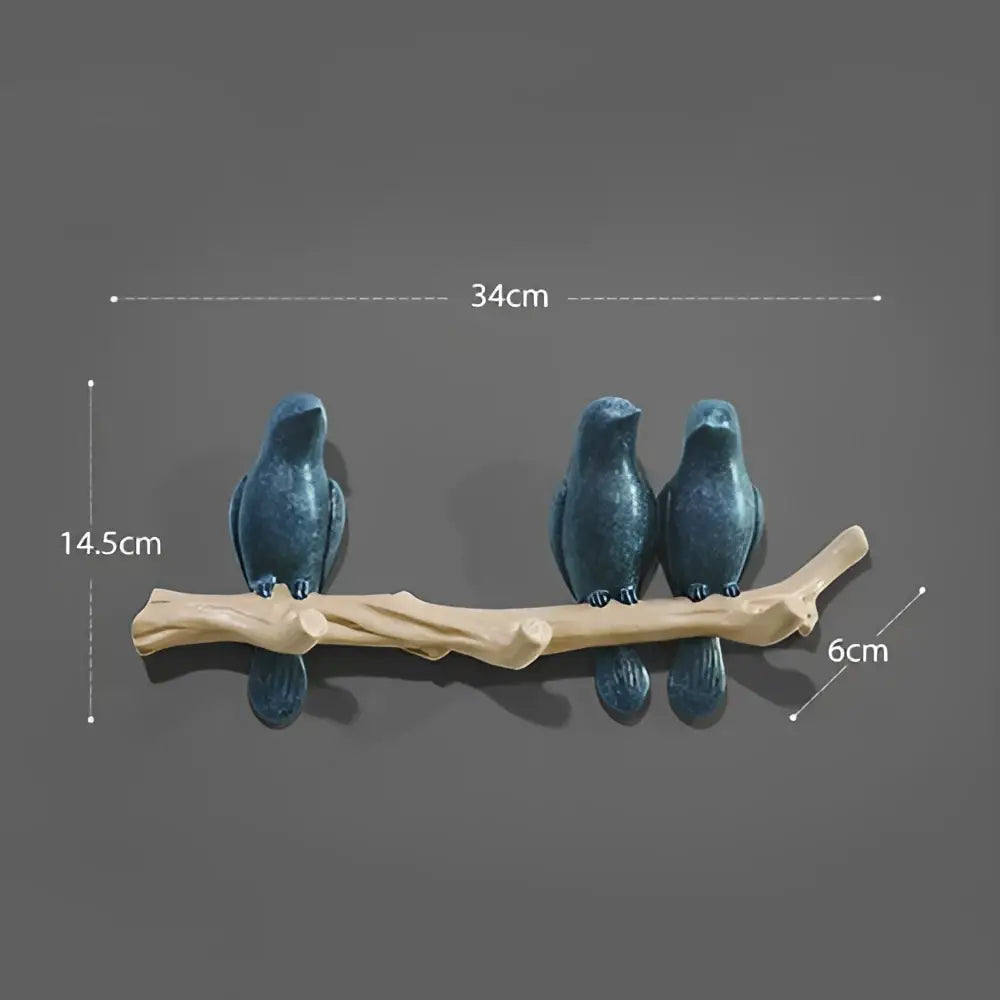 Three dark blue ceramic birds perched on a light brown wooden branch bird resin hanger decorbites bird resin