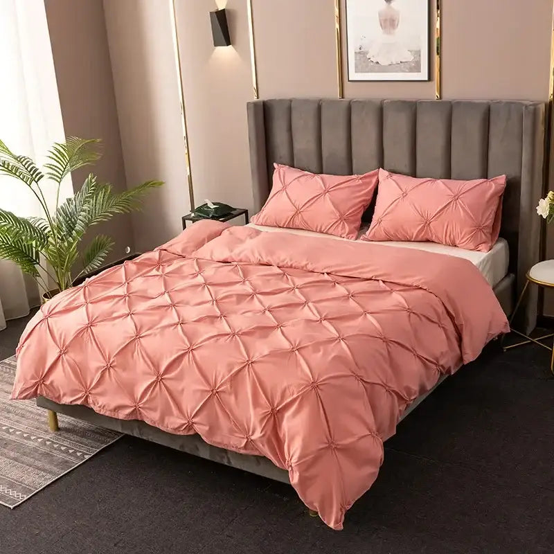 Pink quilted duvet cover set with soft satin-like finish and diamond-shaped pleats for elegant bedroom bedding