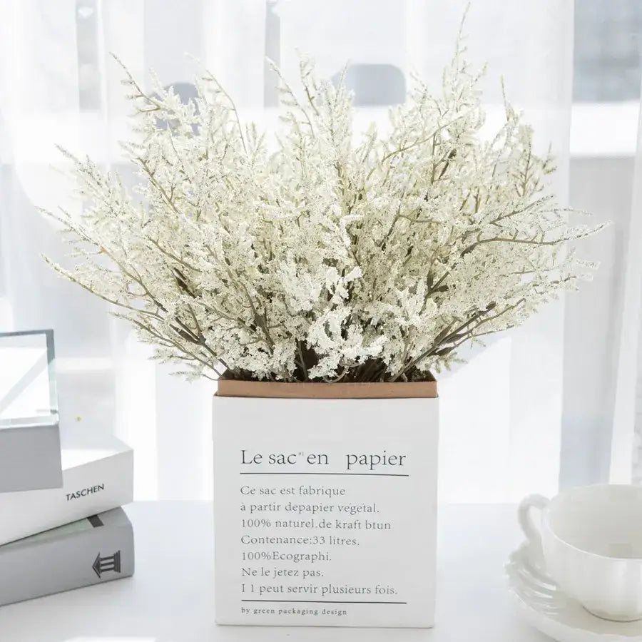 White paper box vase filled with delicate white dried baby’s breath lavender bouquet for living room decor
