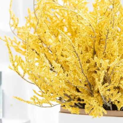 A vibrant yellow dried breath lavender bouquet with delicate feathery branches in a white paper box vase for living room
