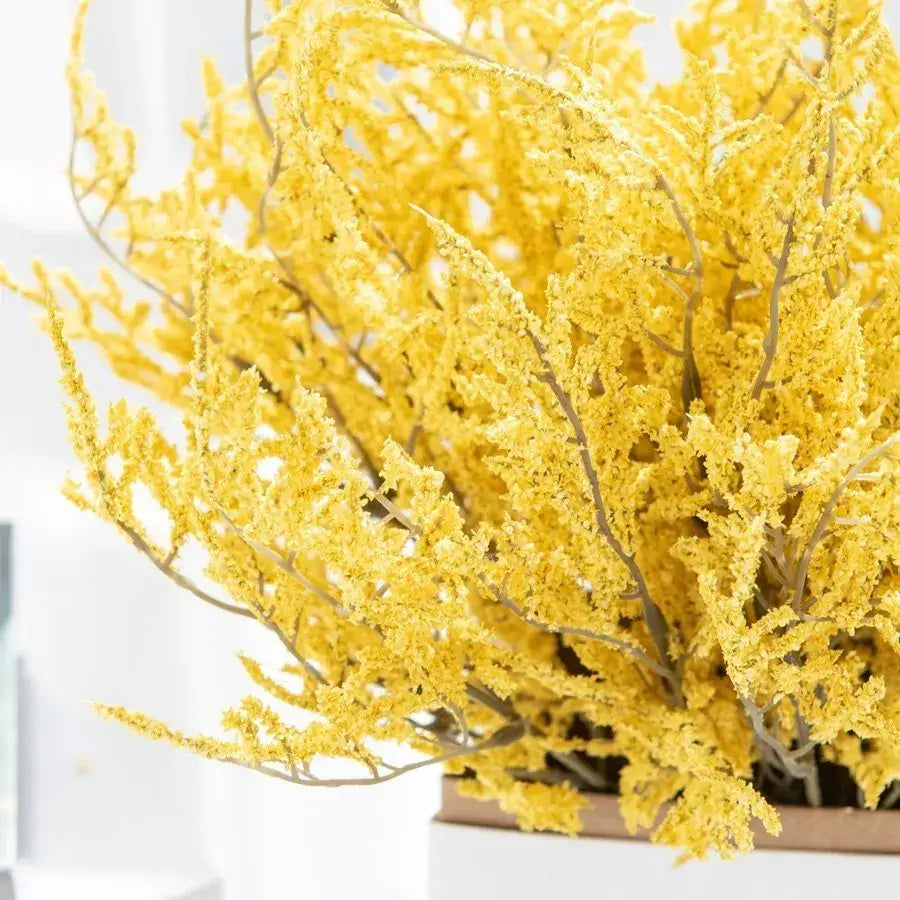 A vibrant yellow dried breath lavender bouquet with delicate feathery branches in a white paper box vase for living room