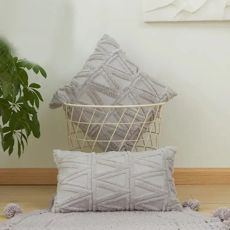 Gray textured throw pillow with geometric pattern tassel trim as an embroidered diamond cushion cover for living room decor