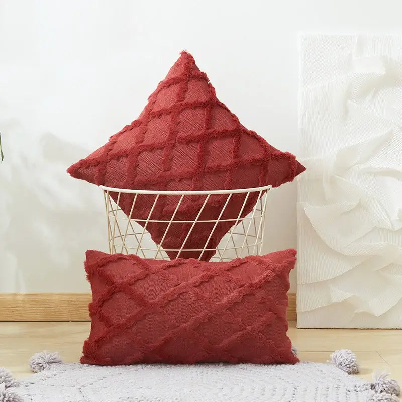 Rust-colored textured throw pillows with embroidered diamond cushion cover and frayed edges for living room decor