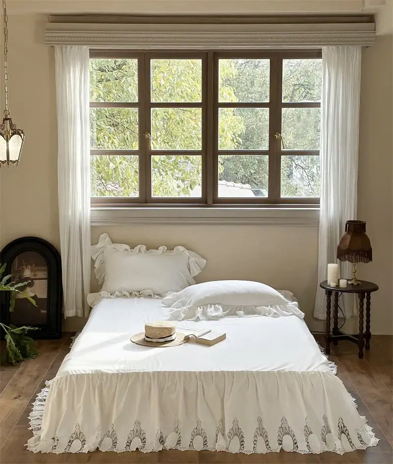 White embroidered lace cotton ruffles bedding set featuring a white ruffled bed skirt with black delicate embroidery